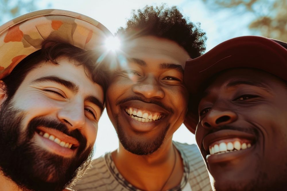 3 happy men laughing outdoors selfie.