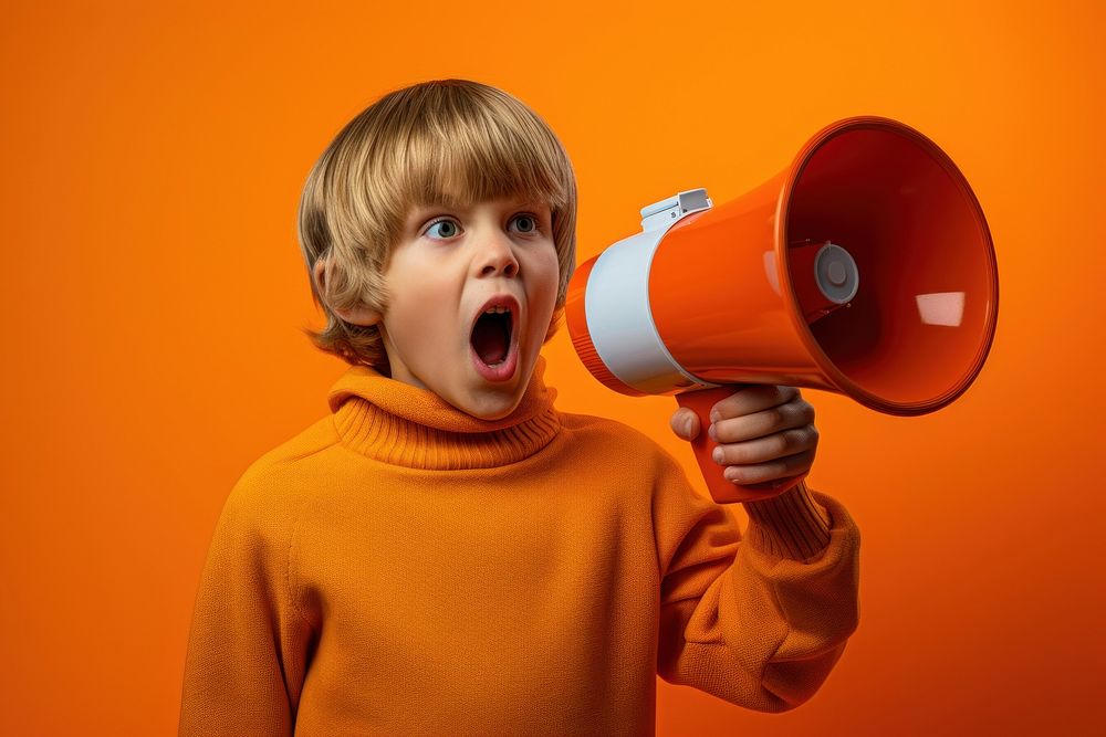 Boy with loudspeaker shouting child appliance.