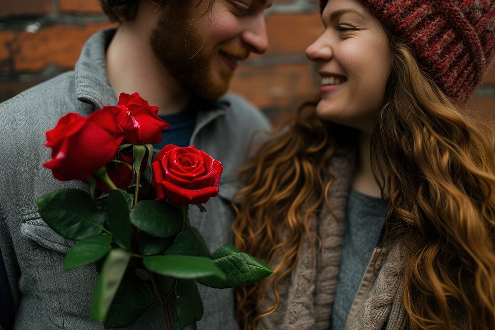 Couple holding red roses flower plant affectionate.