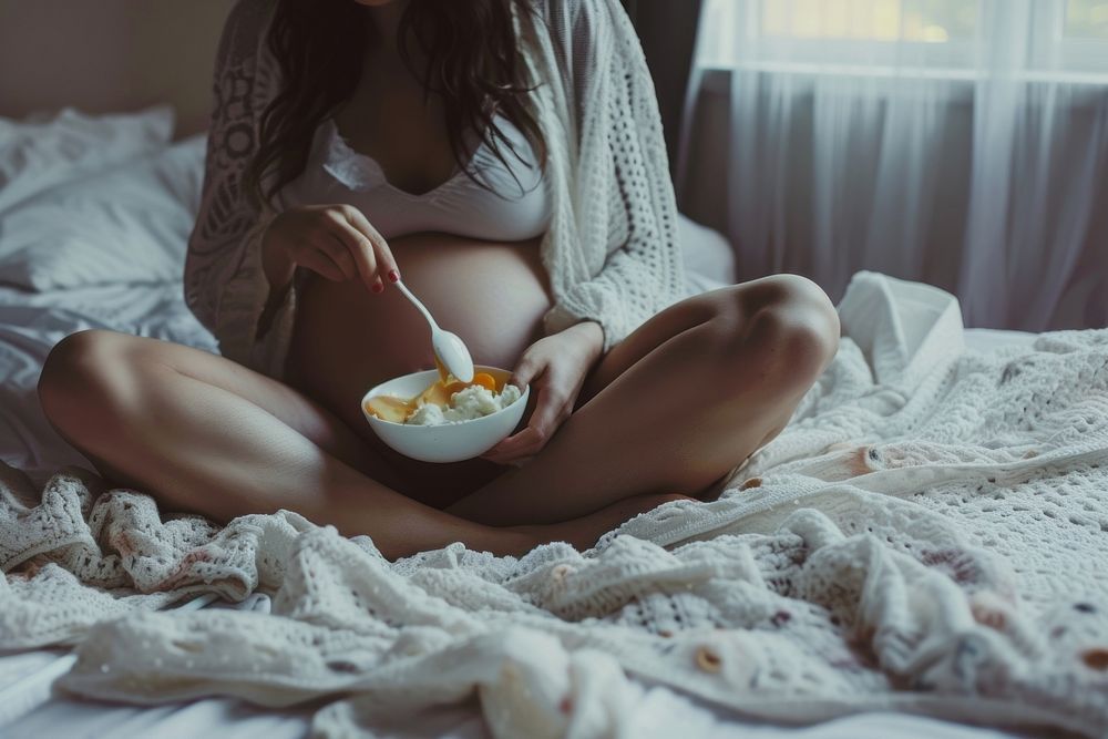 Pregnant woman eating adult food.