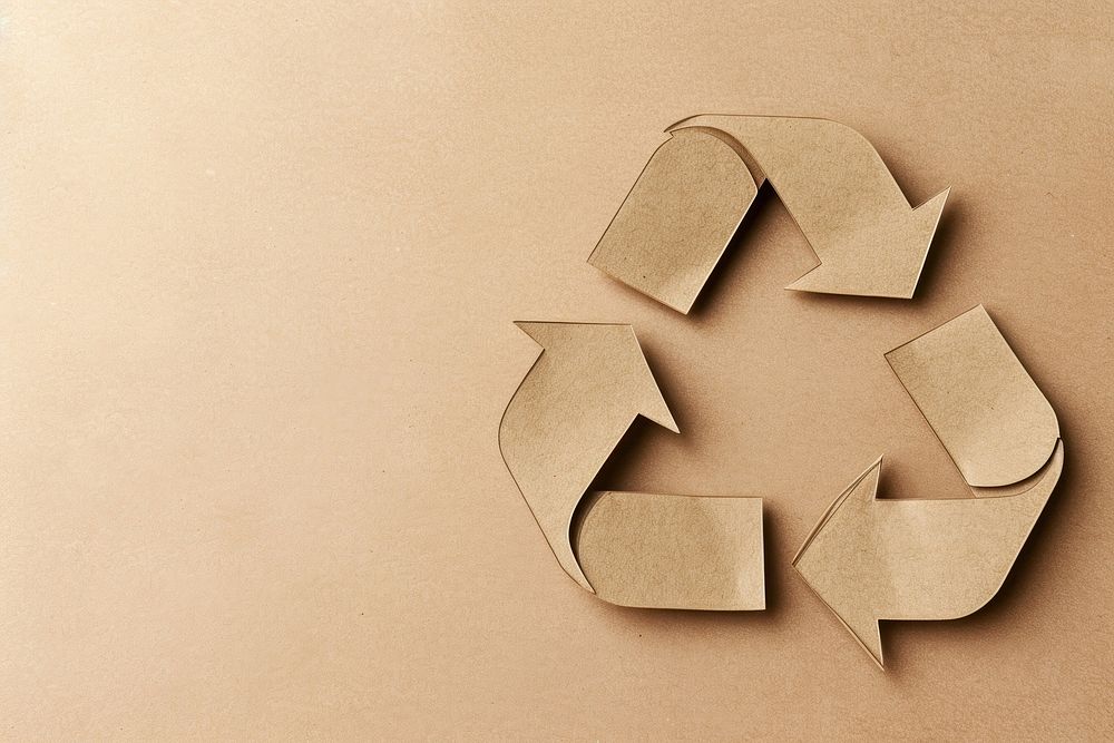 Brown paper cut out shape of the recycling symbol brown cardboard letterbox.