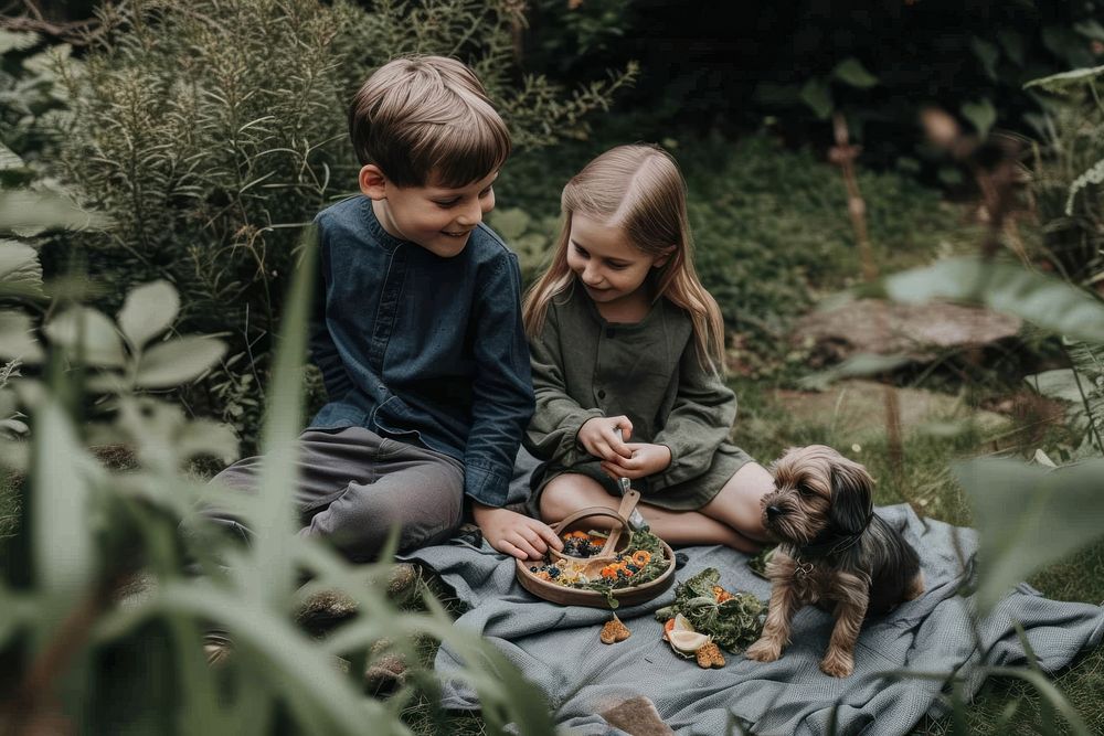 Family kid with puppy picnic in small garden child togetherness friendship.