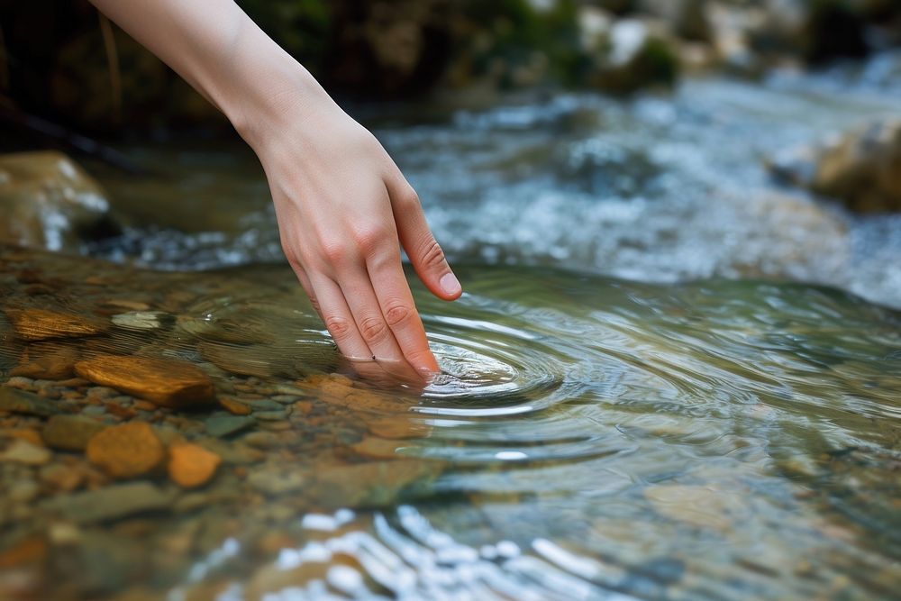 Hand touching the river water outdoors nature finger.