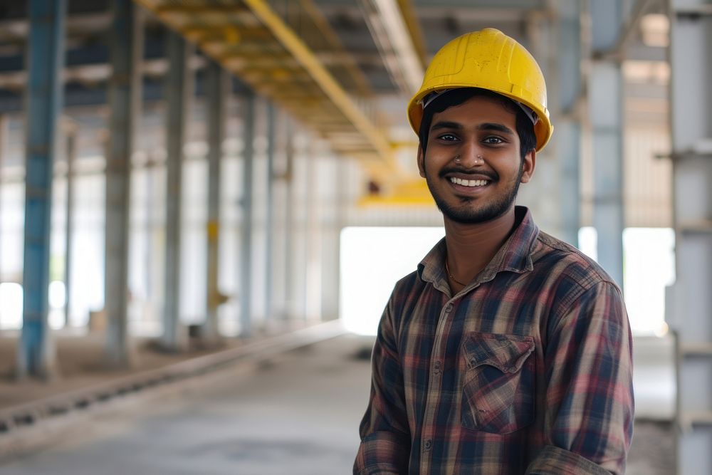 Smiling young Indian architect man hardhat helmet adult.