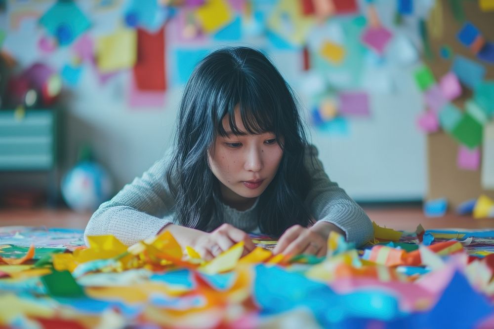 Japanese girl using stationary concentration contemplation paintbrush.
