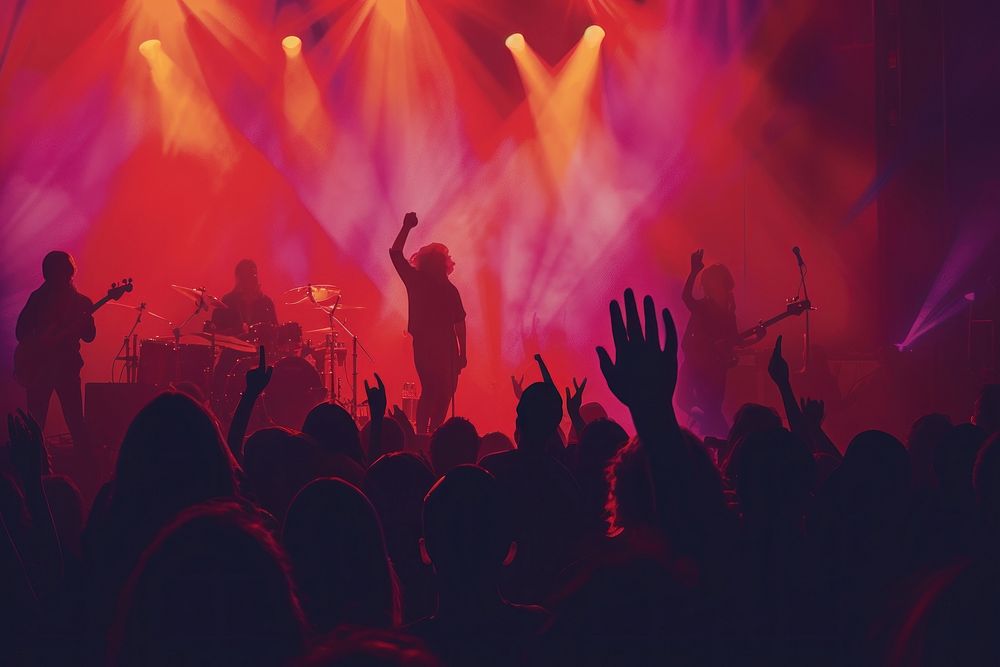 A Silhouette of people raise hand up in concert silhouette microphone nightlife.