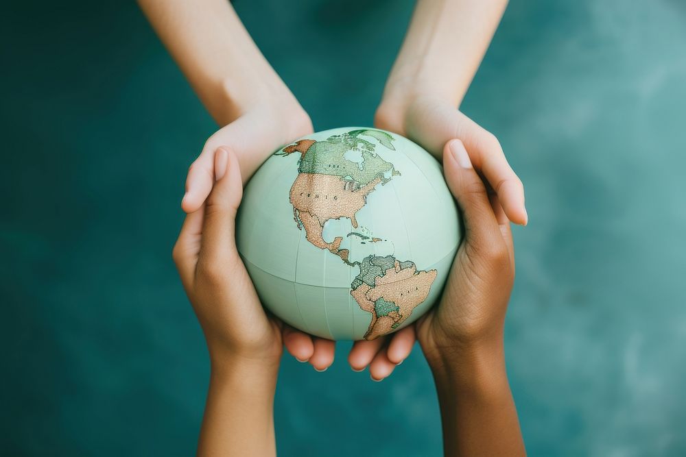 3 people hands holding a paper craft Globe globe planet green.