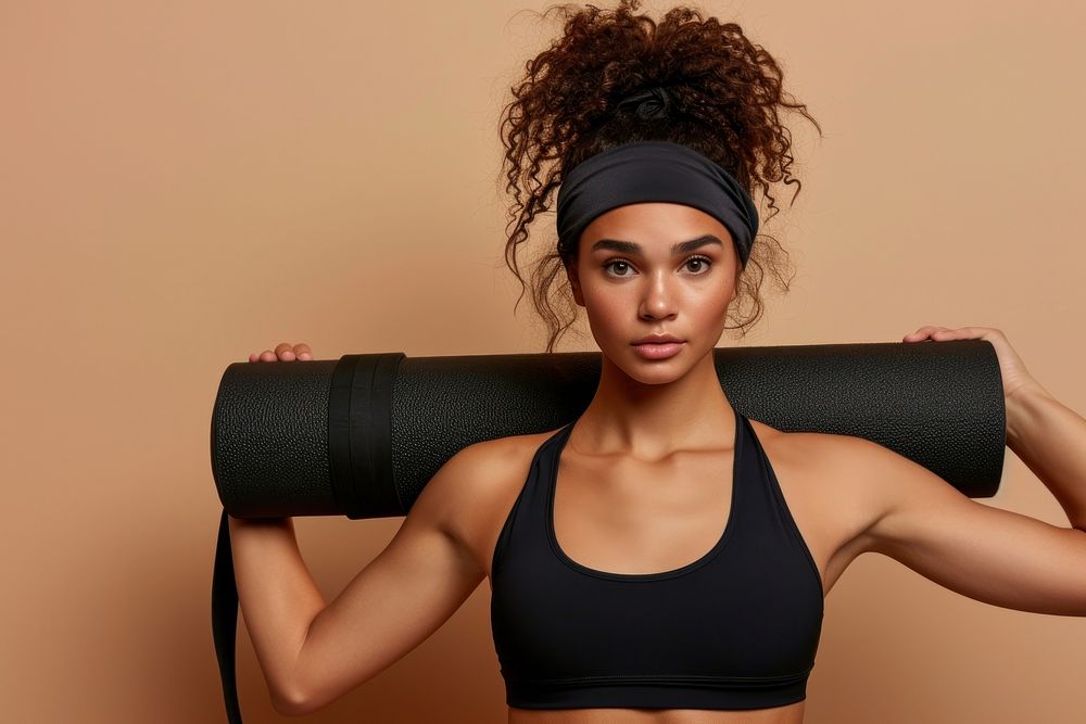 Active woman holds an exercise mat portrait sports adult.