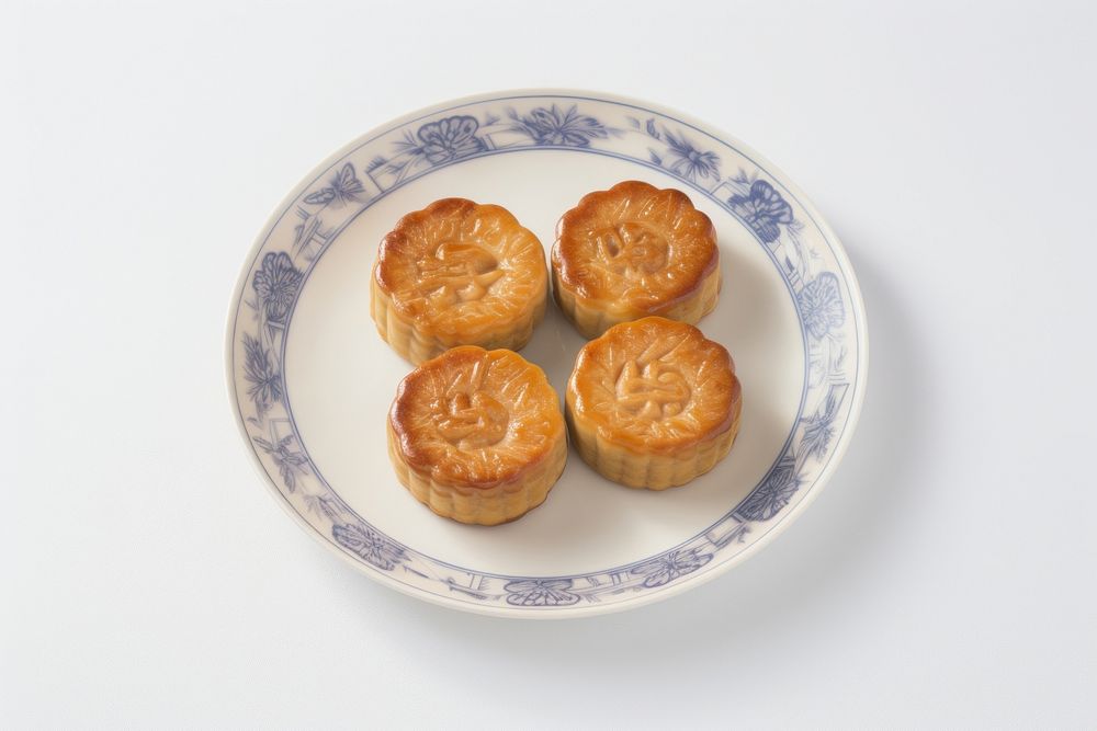 A chinese mooncake cut open arranged put on plate dessert food meal.