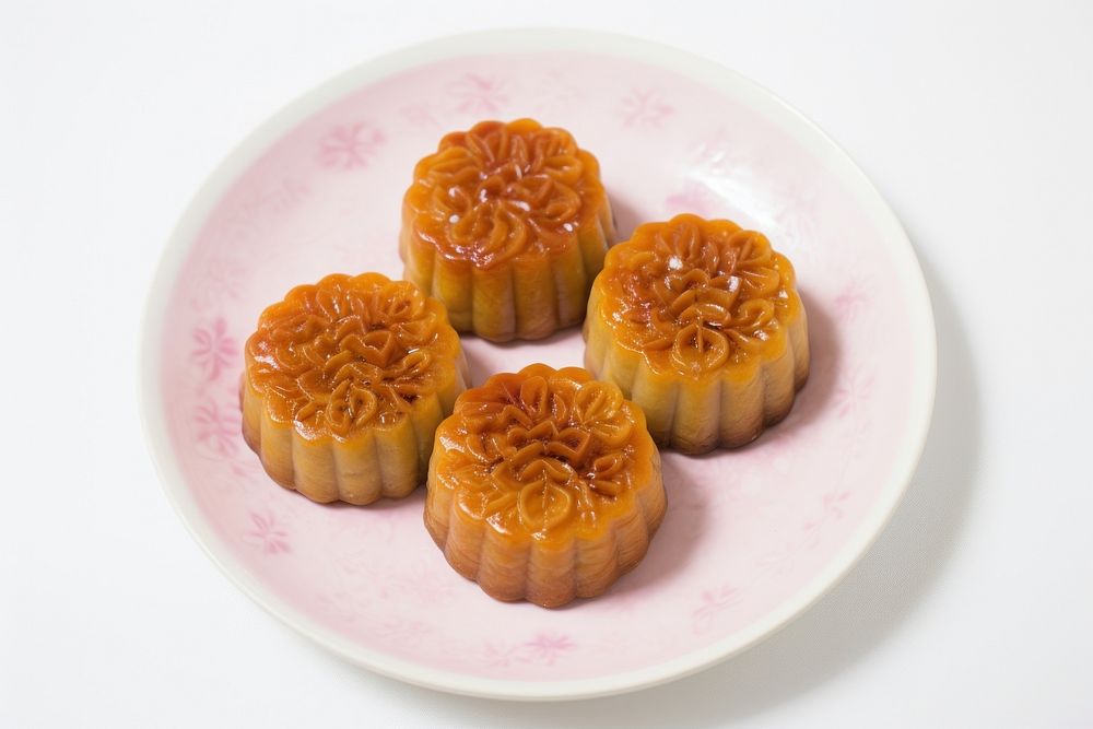 A chinese mooncake cut open arranged put on plate dessert food dish.