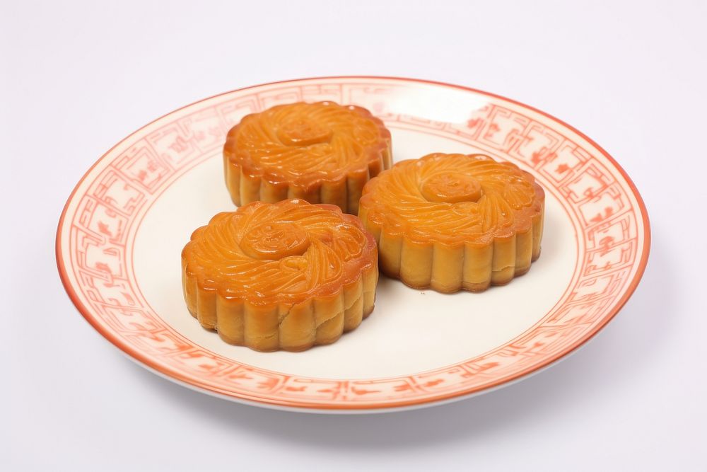 A chinese mooncake cut open arranged put on plate dessert food confectionery.