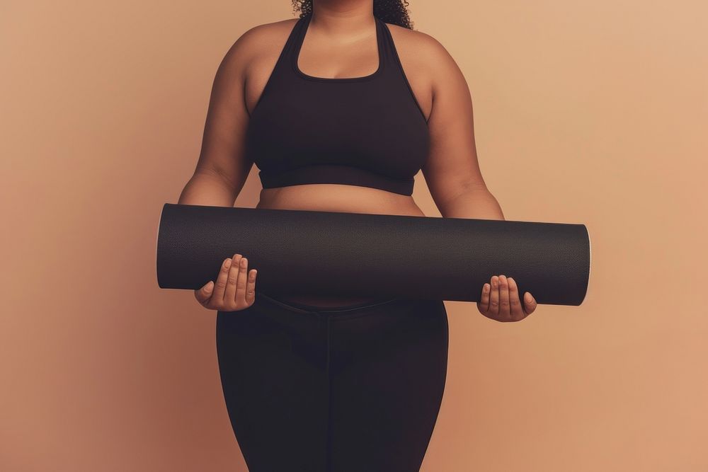 Fat woman holds an exercise mat sports exercising relaxation.