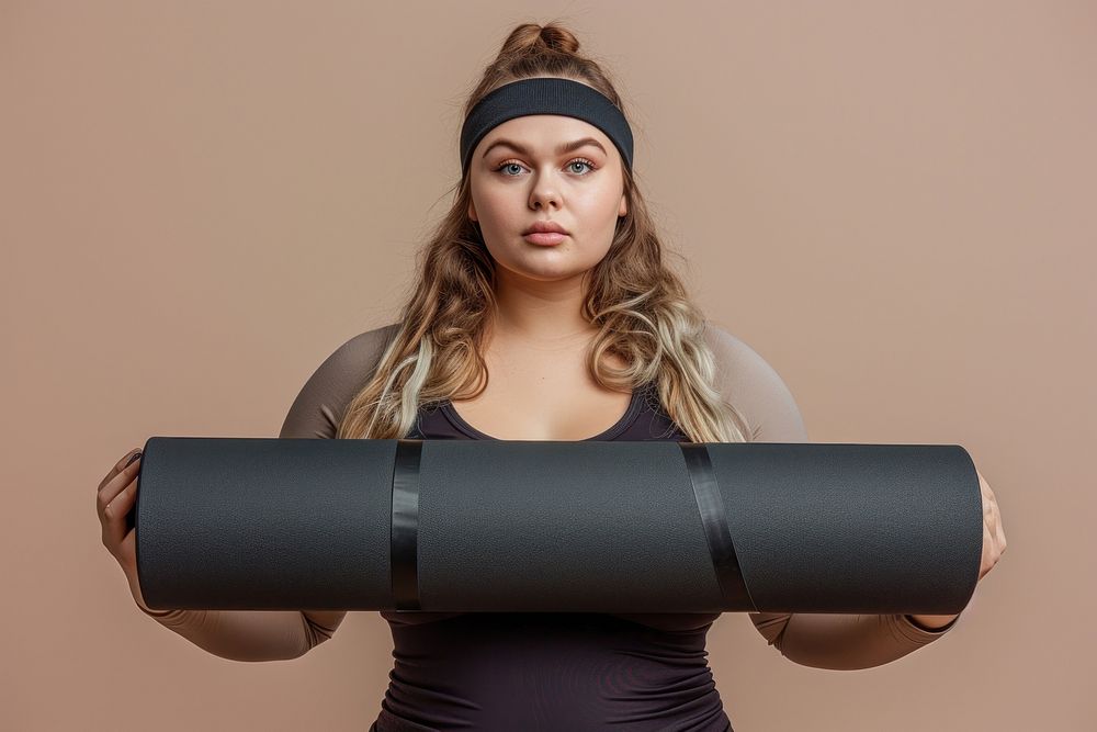 Fat woman holds an exercise mat portrait sports photo.