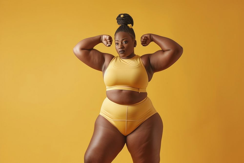 Fat black woman flexing muscle pose portrait swimwear sports.