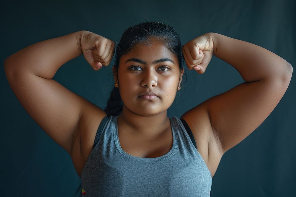 Fat south asian woman flexing muscle portrait sports adult.