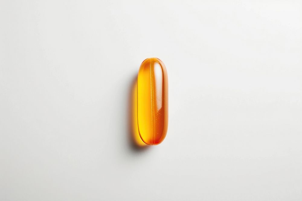 Vitamin capsule pill white background.