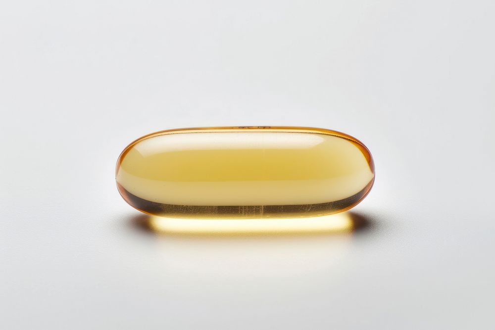 Vitamin capsule pill white background.