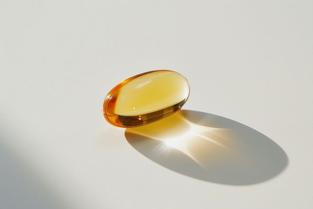 Vitamin jewelry pill white background.