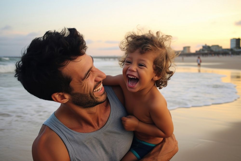 Brazilian dad spend time with son laughing portrait outdoors.