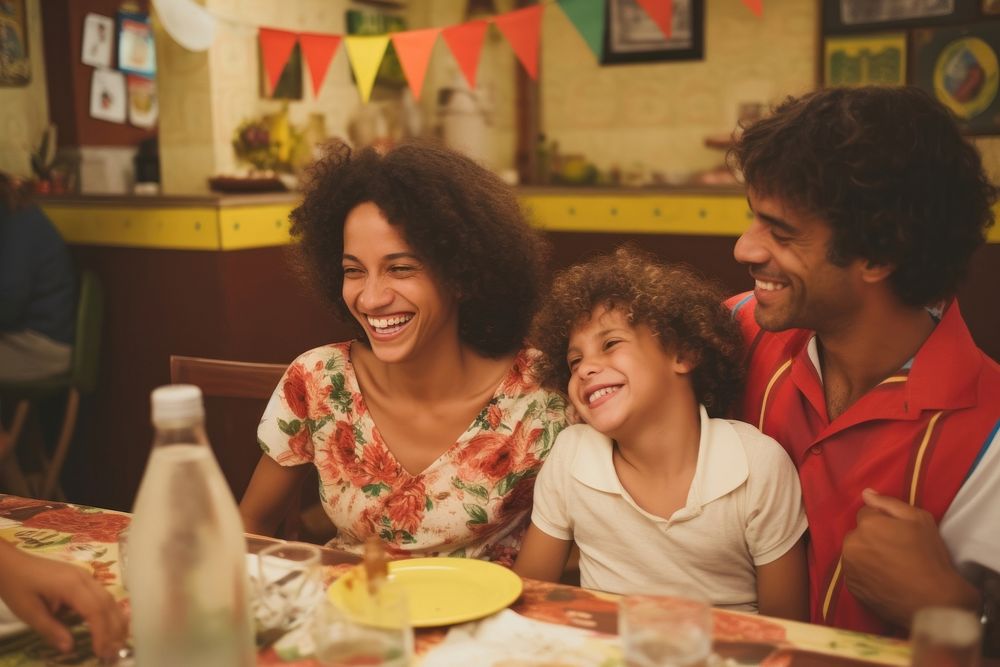 Brazilian family spend time in the restaurant laughing adult child.