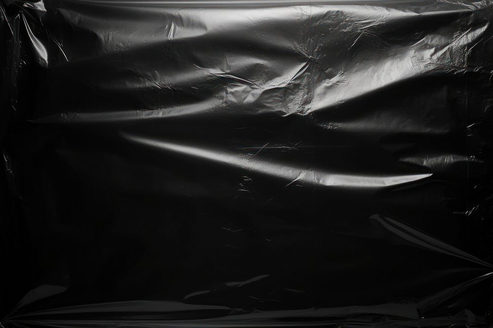 Transparent plastic wrap over black background backgrounds transportation monochrome.