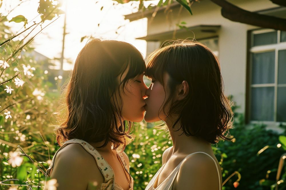  Two women kissing portrait outdoors adult. AI generated Image by rawpixel.