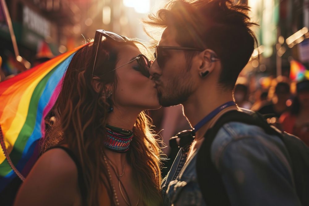  Man and transwoman with rainbow flag kissing in the parade adult affectionate togetherness. AI generated Image by rawpixel.