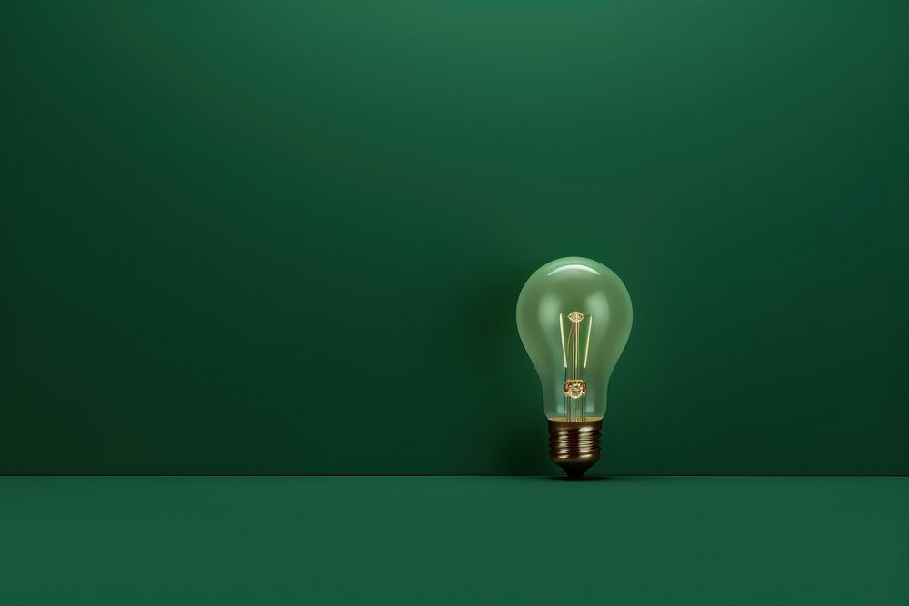  Sage green background with a shining light bulb border lightbulb electricity illuminated. 