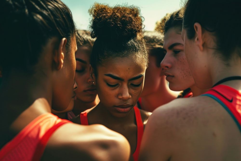 Athletes standing in a huddle photography portrait sports.