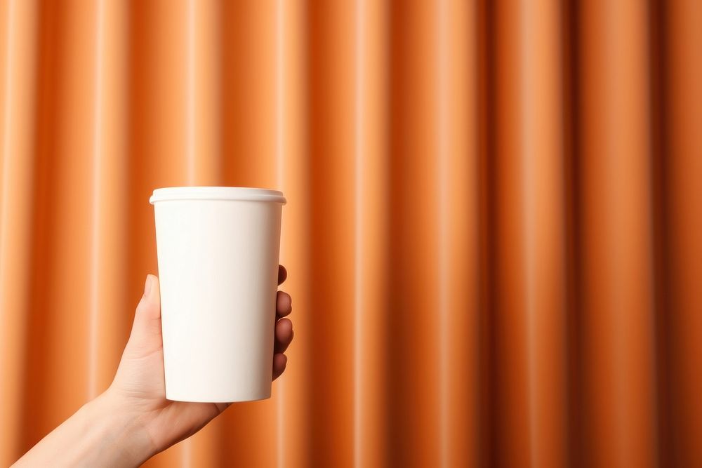 Coffee cup  curtain holding hand.