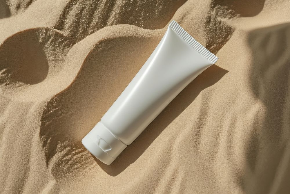 Tube skincare packaging  sand cosmetics sunscreen.