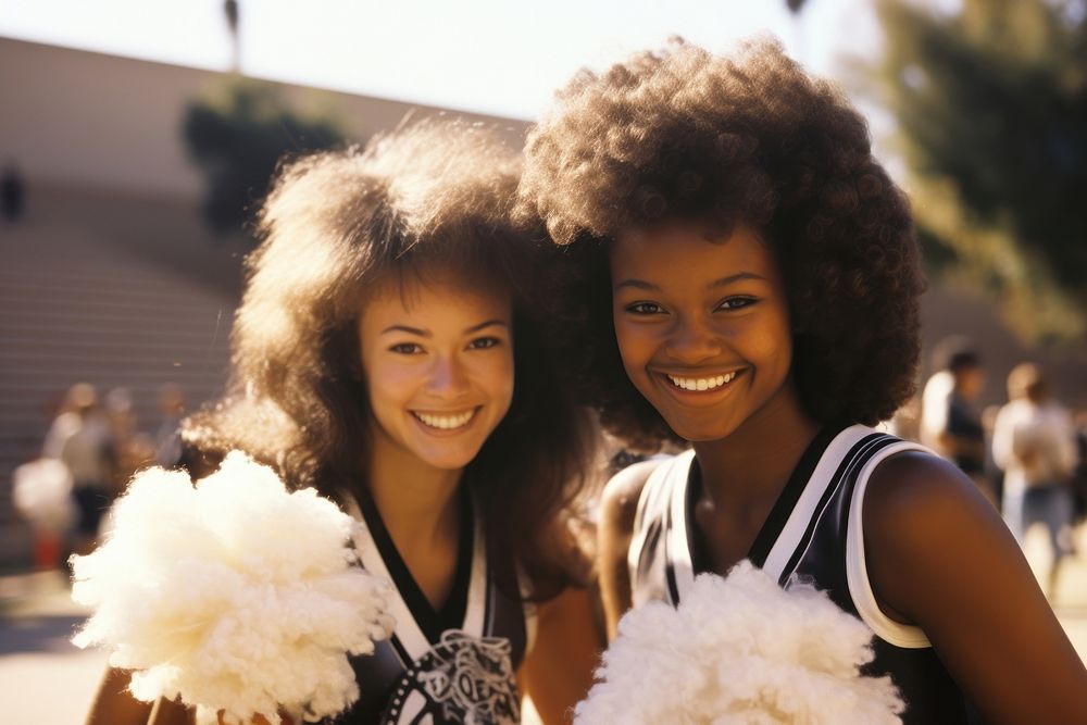 Two females cheerleaders with pom poms portrait smile adult.