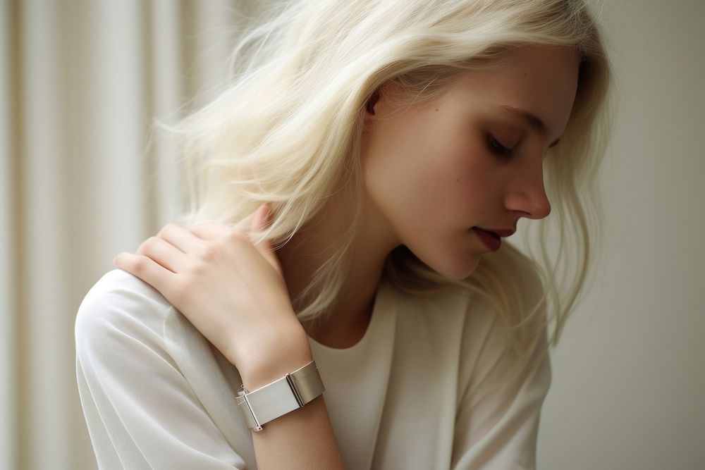Woman touch her own shoulder watch contemplation wristwatch.