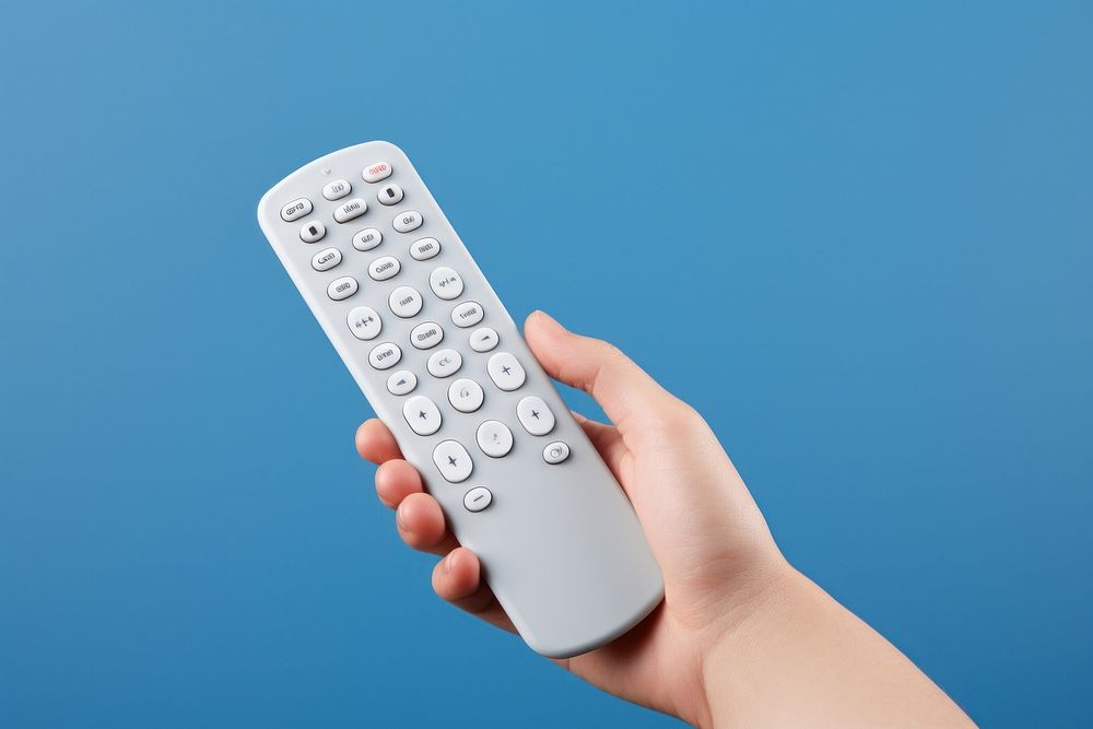 A hand holding remote control electronics calculator technology.