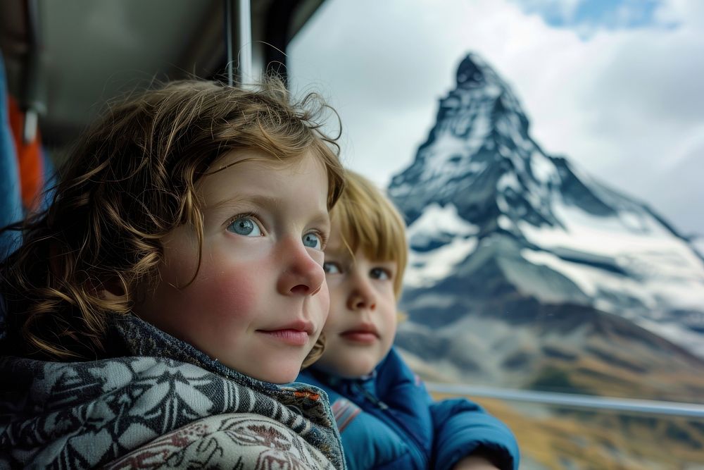 Kid with mother in a train mountain landscape portrait.
