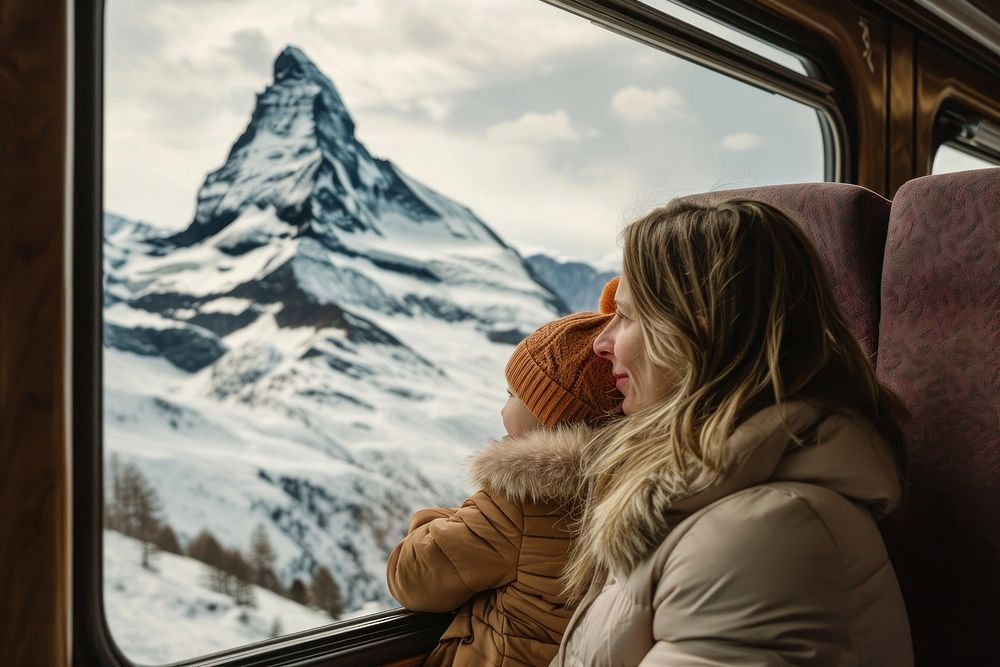 Kid sit with mother in a train mountain outdoors nature.