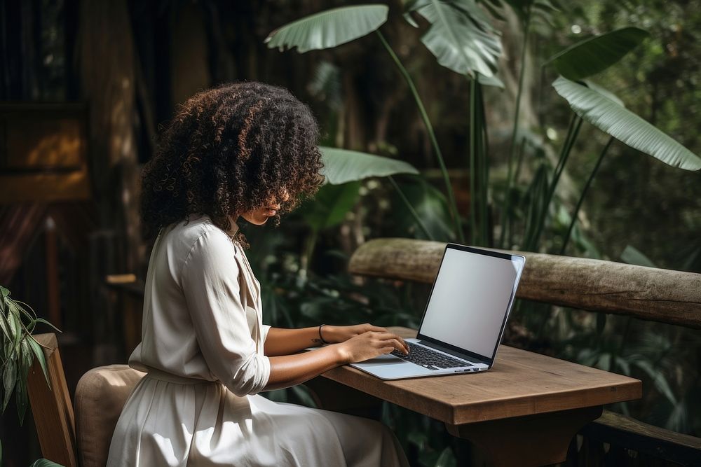 Black woman uses laptop furniture computer sitting.