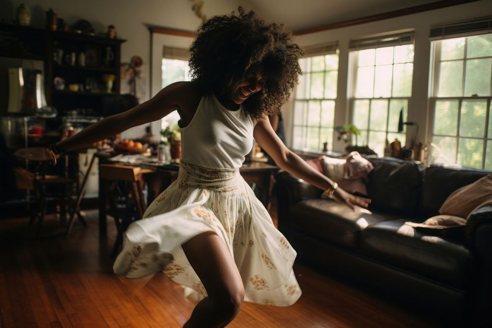 Black woman dances in the living room dancing performance accessories.