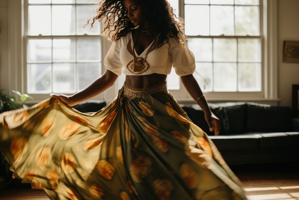Black woman dances in the living room fashion dancing dress.