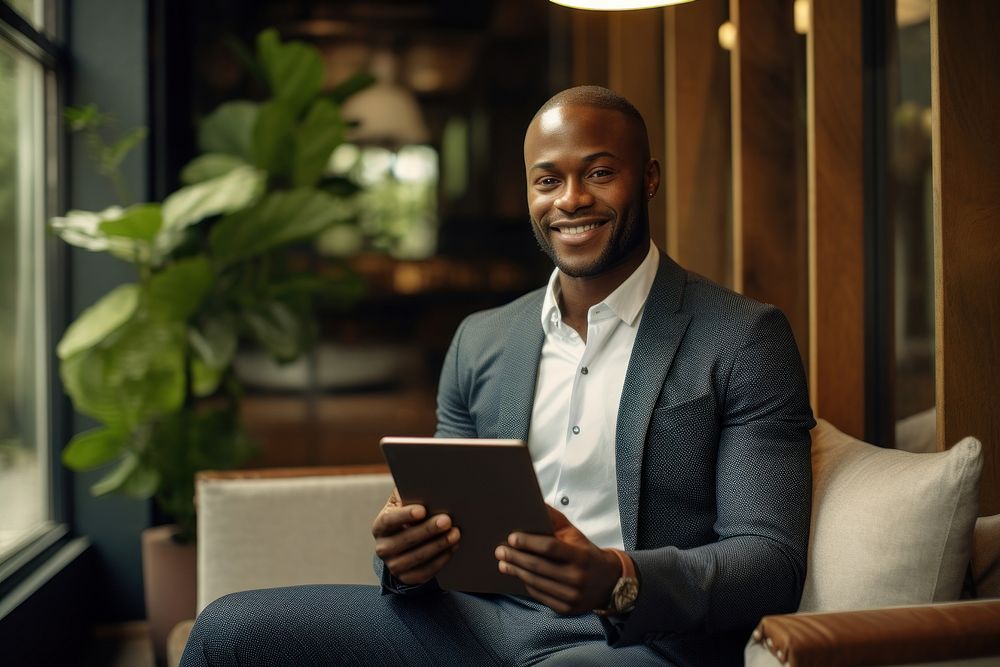Business black man sitting and holding tablet smiling adult portability.