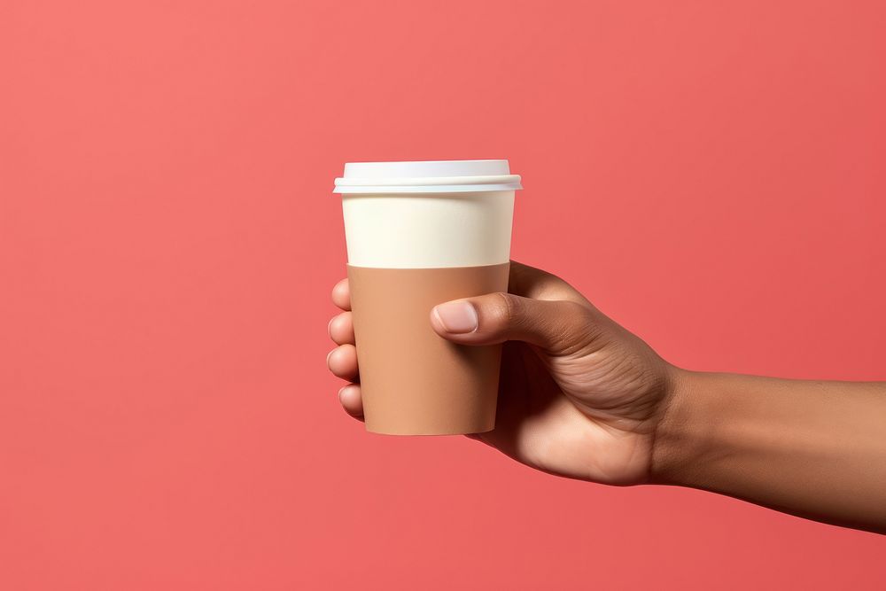 Coffee cup on hand holding latte drink.