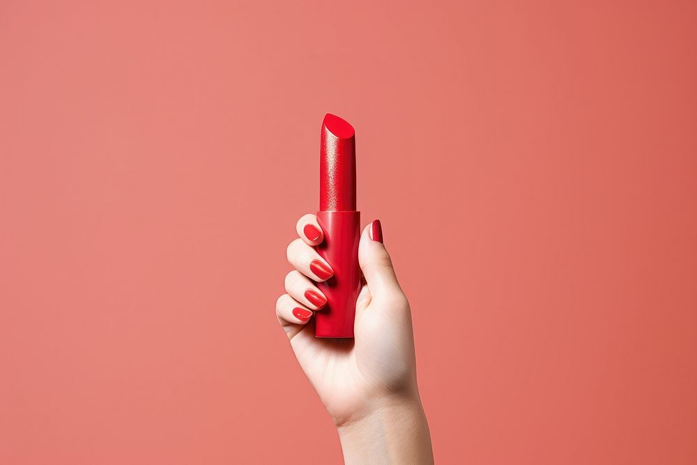 Lipstick on hand cosmetics holding finger.