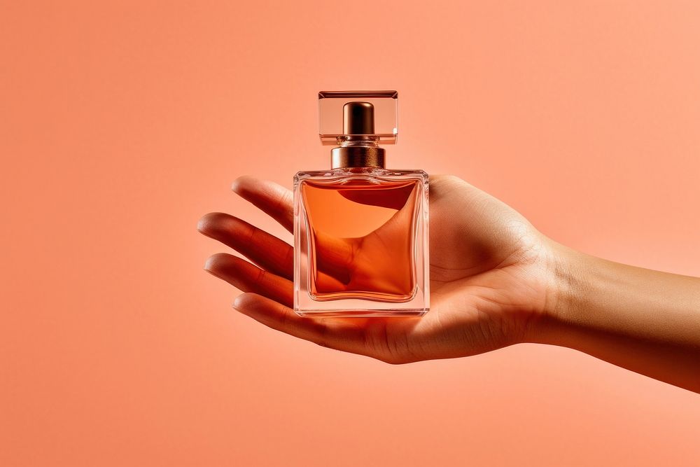 Perfume on hand cosmetics holding bottle.