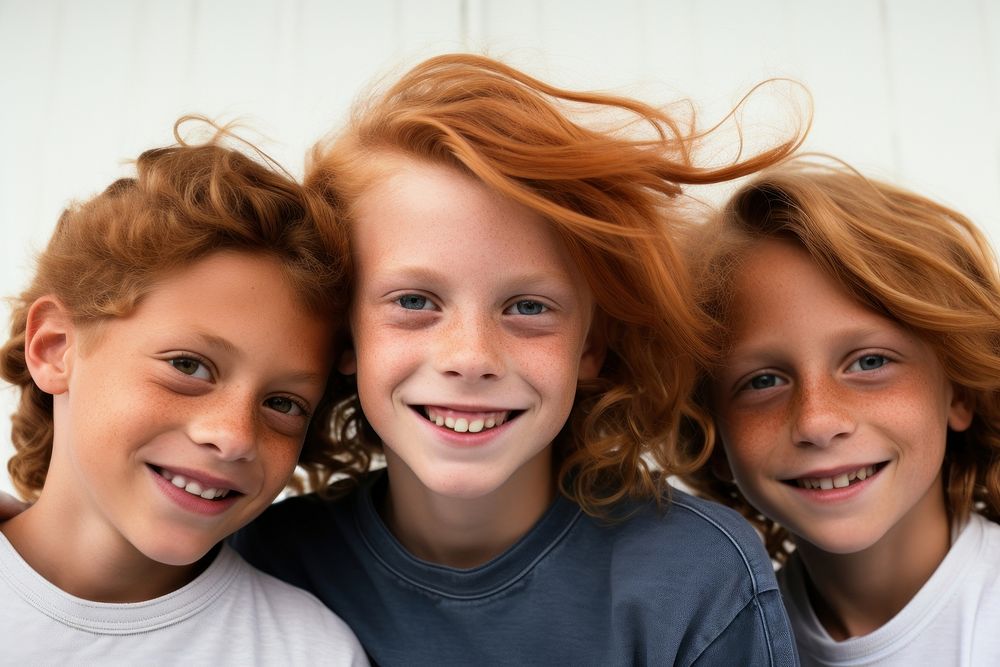 Ginger hair young boy with friends portrait laughing child.