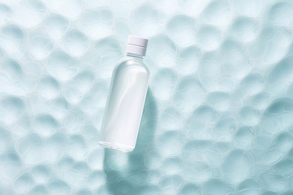 White dropper bottle on water floor pattern refreshment container cosmetics.