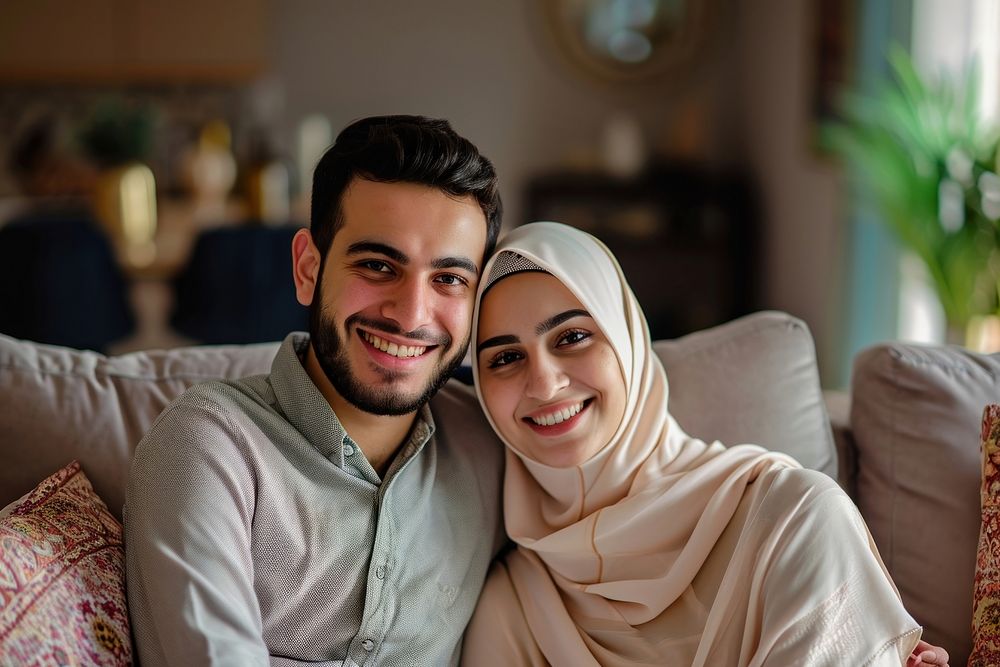 Middle eastern couple sitting on couch smiling adult love.