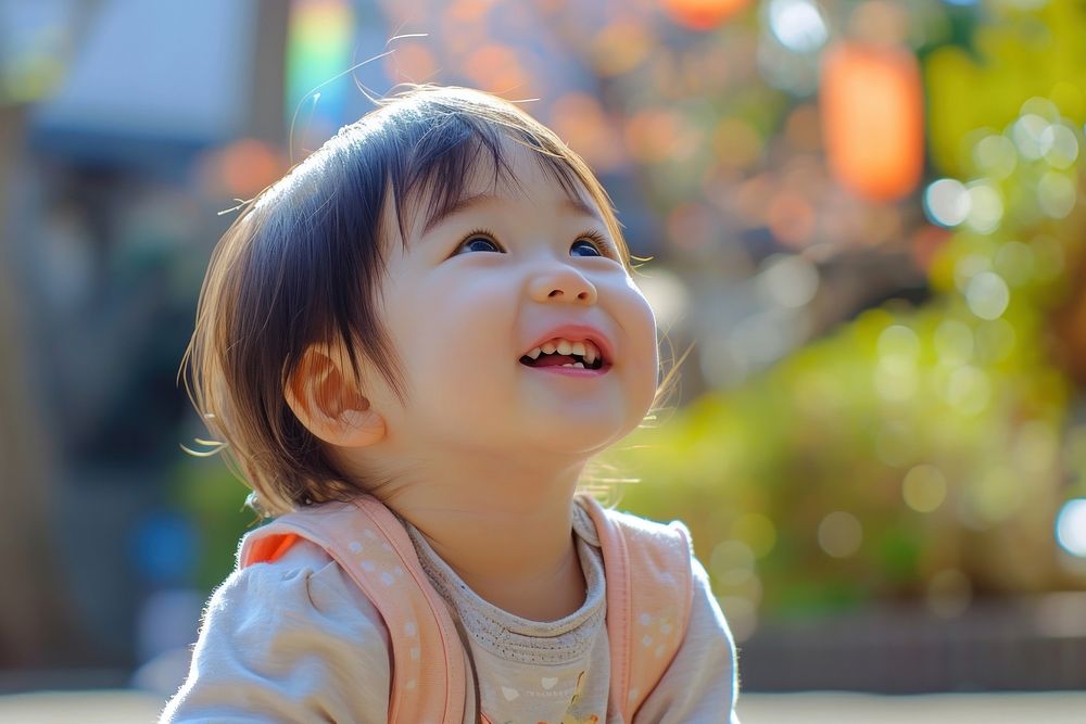 Asian toddler cheerful portrait outdoors.