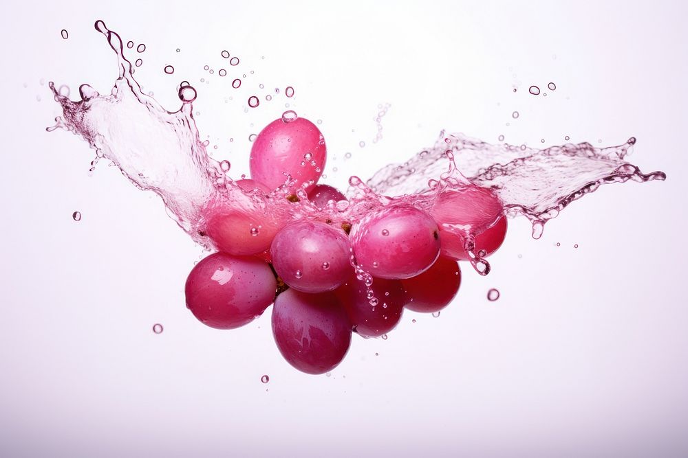 Grapes with pink splash falling plant macro photography.