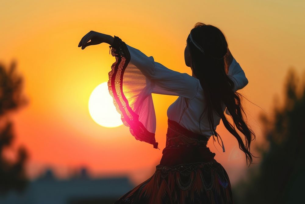 Middle Eastern girl dancing sunset adult backlighting.