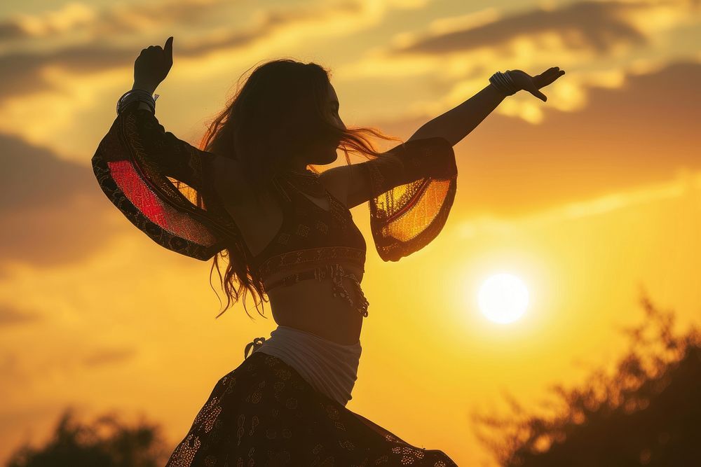 Middle Eastern girl dancing backlighting sunset summer.